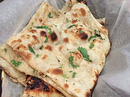 Soft Indian naan bread best paired with creamy chicken tikka masala curry
